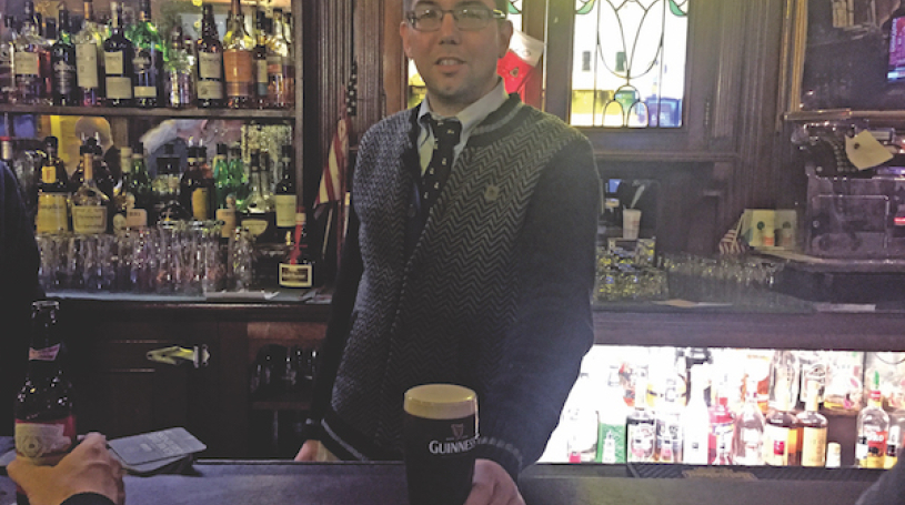 Fourth-generation Peter McManus Cafe owner Justin McManus serves up a well-poured Guinness. File photo by Dennis Lynch.